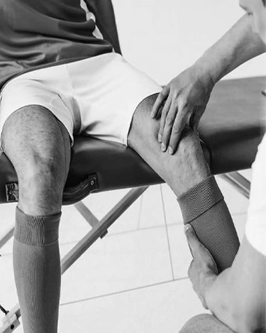 Physiotherapist assessing a patient's knee